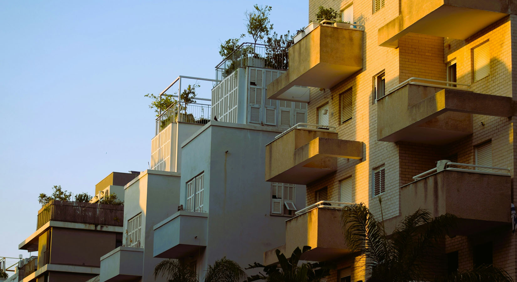 Placeholder image of several buildings at sunset